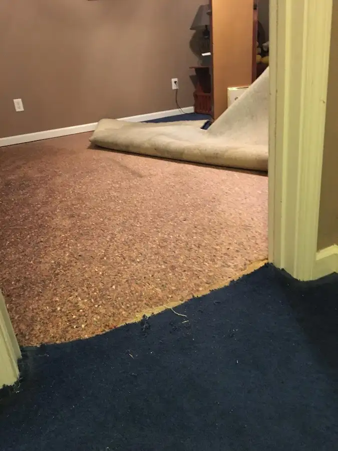 Carpet pad removal revealing water damage during Drying & Dehumidification in Fort Scott