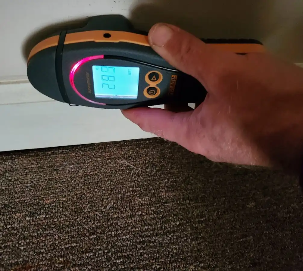 Moisture detection at baseboard during Storm Damage Restoration in Fort Scott